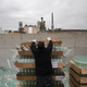 Workers unload defective glass bottles to be recycled